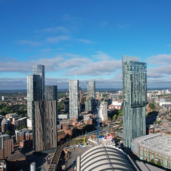 Manchester aerial view showing tall, modern buildings and blue sky