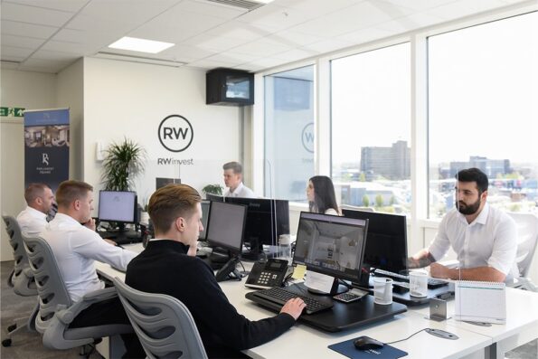 Workers at RWinvest Manchester office using computers and talking on the phone