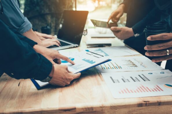 A group of property investors having meetings and with documents on their table looking at investment and market trends