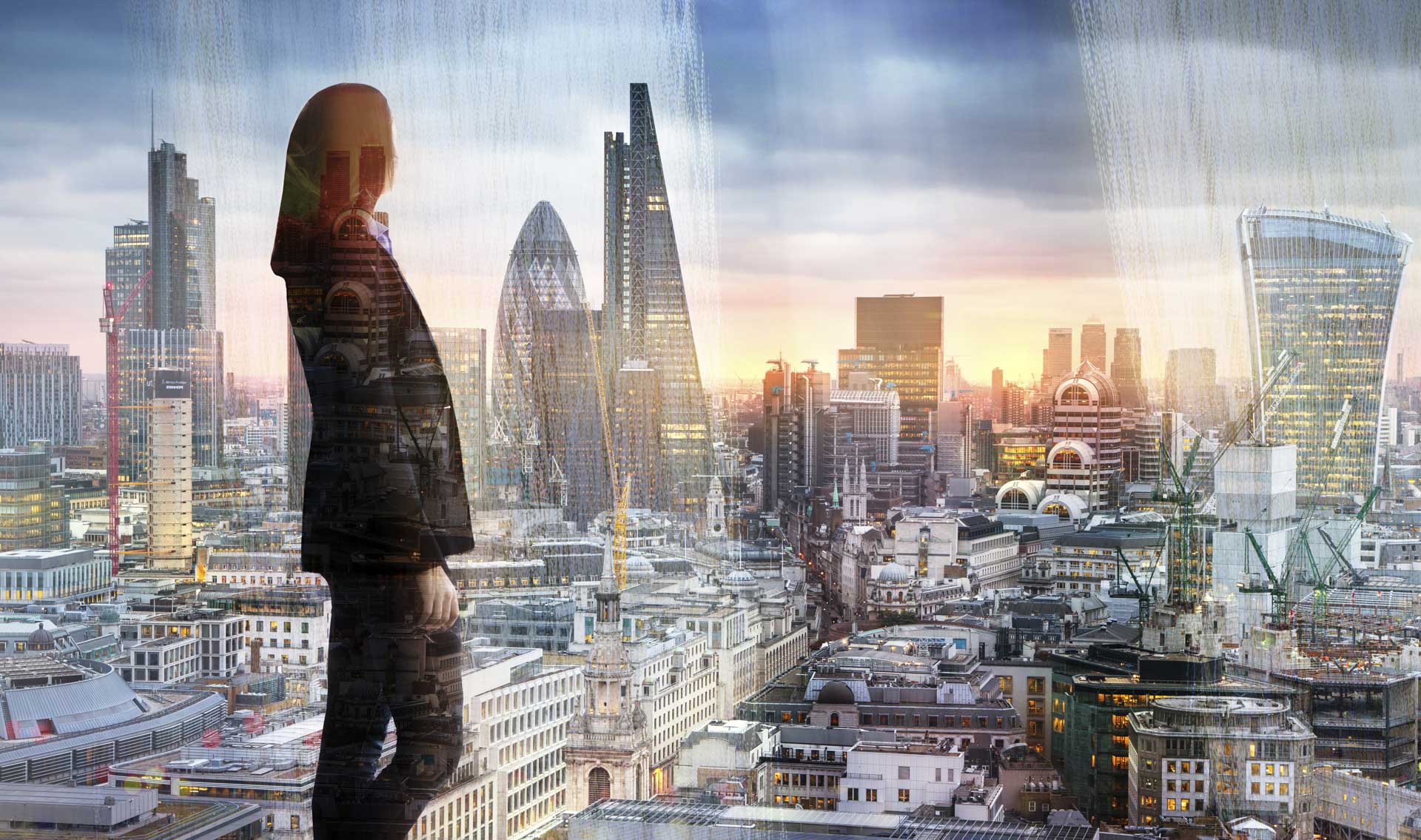 Young woman looking at the City of London, financial district. Early morning. Sun rise. Future, planning and business progress concept.
