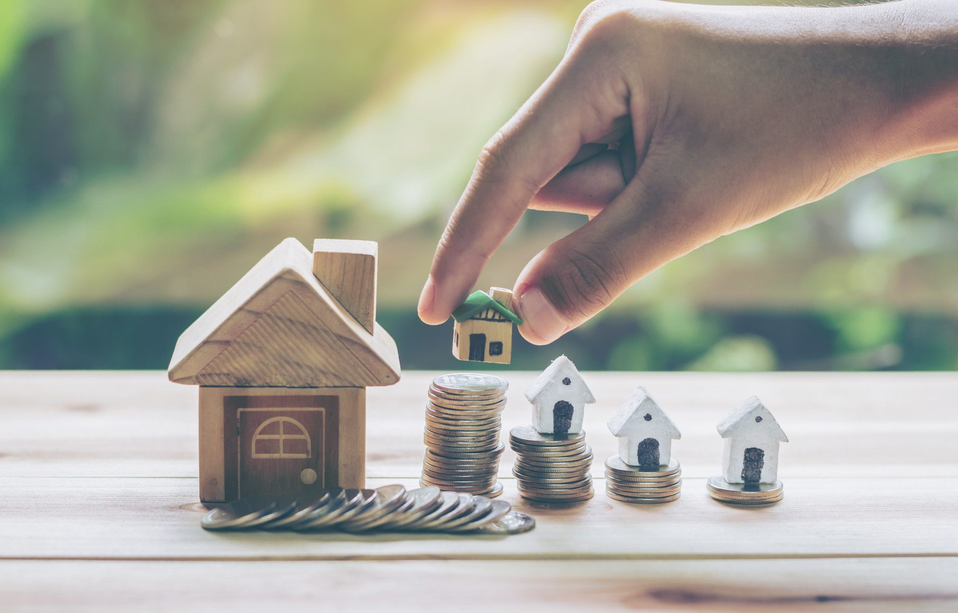 House placed on coins Men's hand is planning savings money of coins to buy a home concept concept for property ladder, mortgage and real estate investment. for saving or investment for a house,