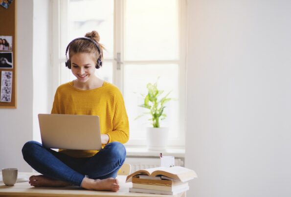Lady joyfully looking at her laptop