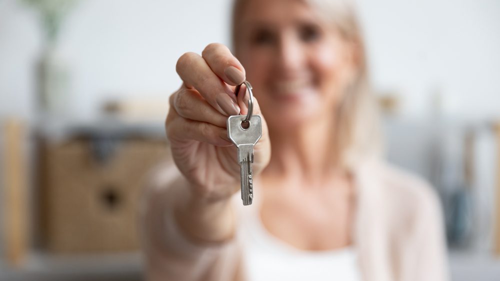 Landlord handing the key over to you