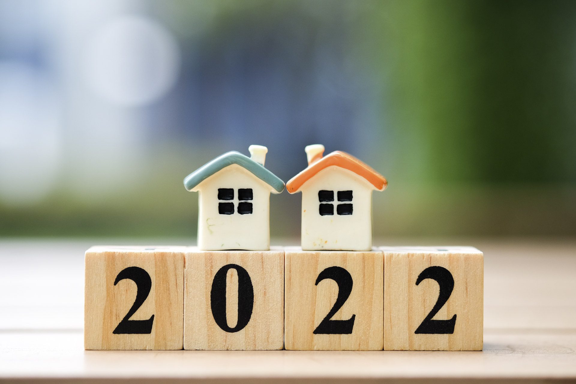 Two house model on 2022 wooden blocks number. New year property investment concept.