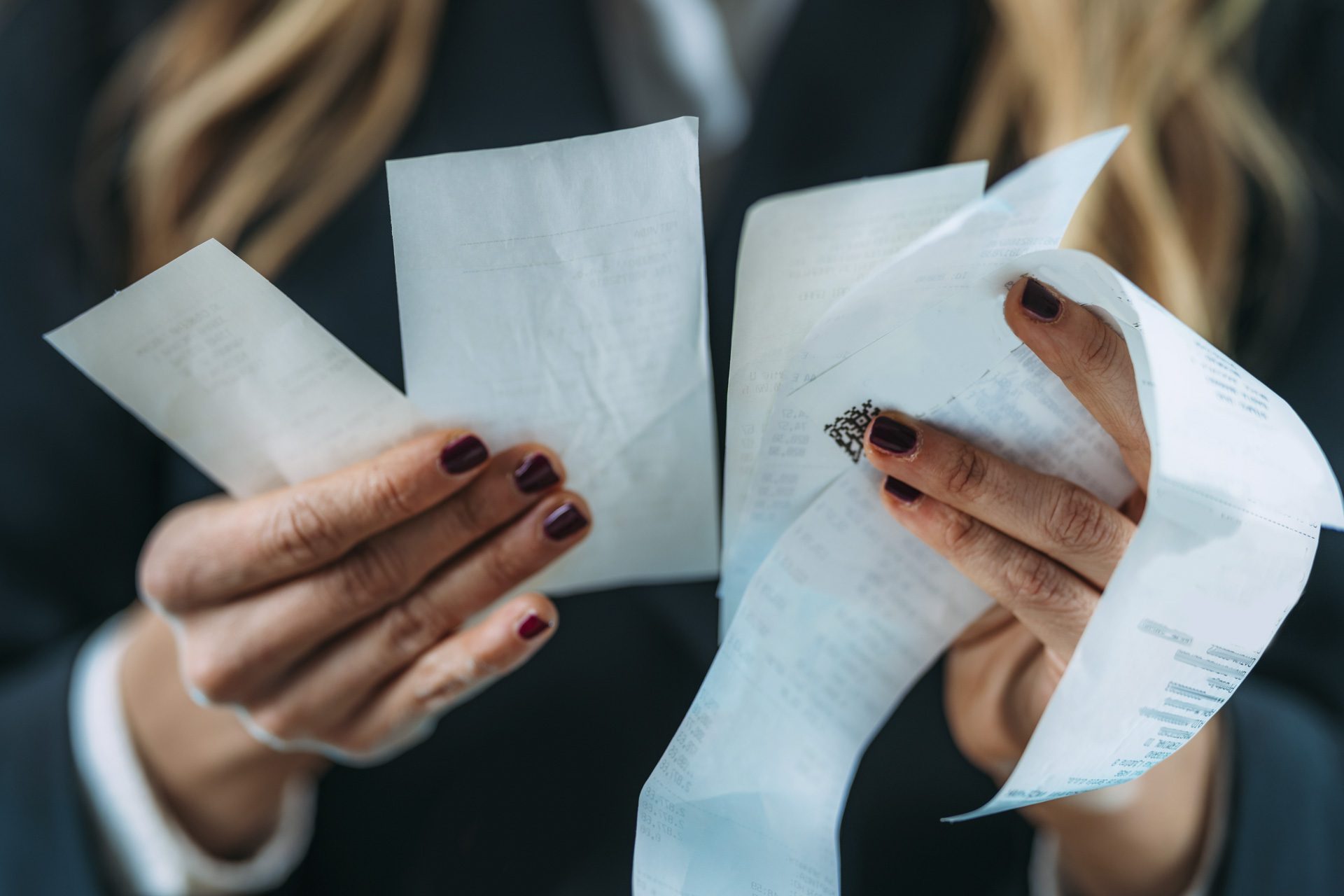 Inflation rising, costs increasing. Business woman holding Rising costs, declining standard of living, worried woman looking at increased costs on a printed receipt