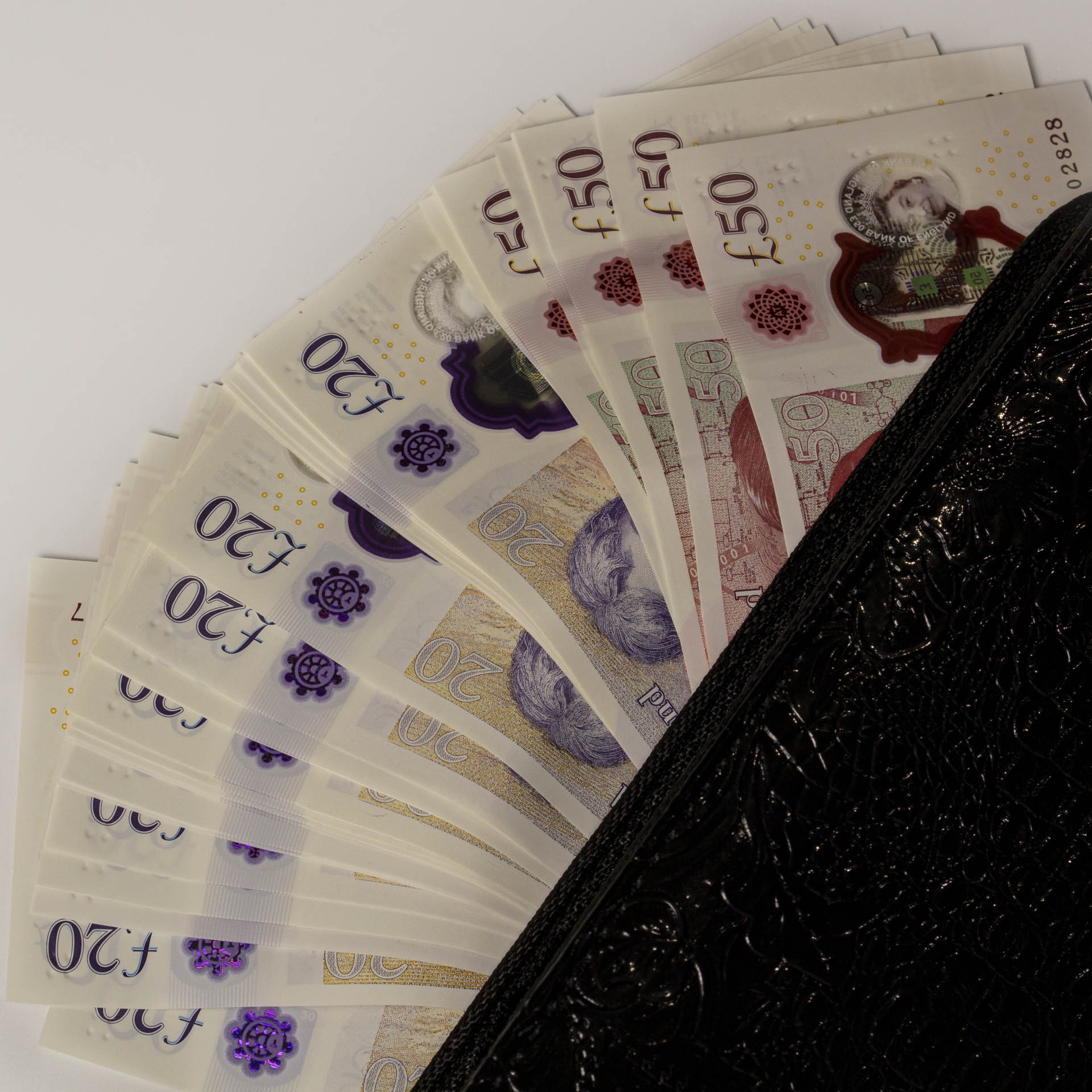 an open wallet with British pounds peeking out