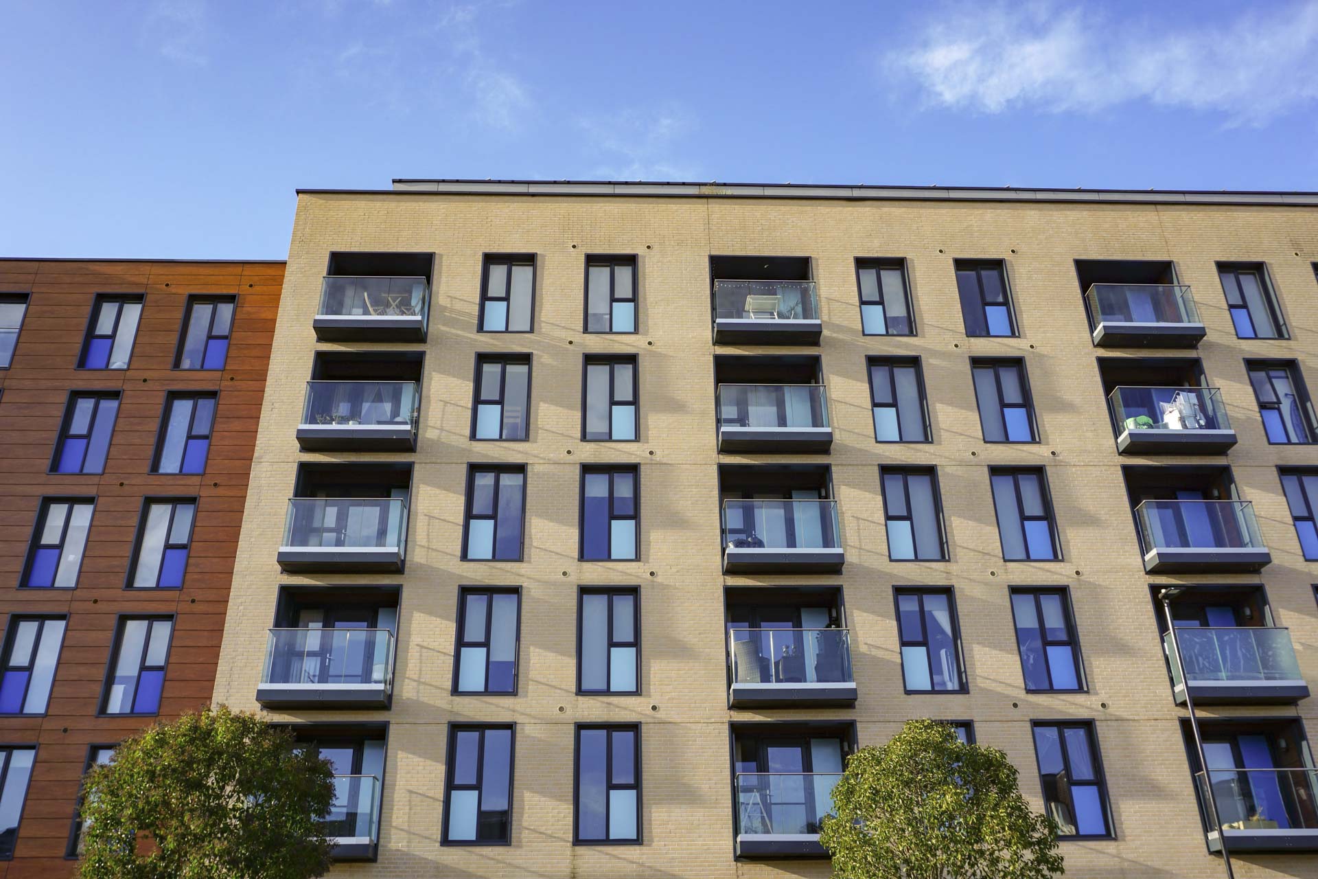 modern apartment building in city. front exterior of newly built apartment block with balconies. city living in the UK