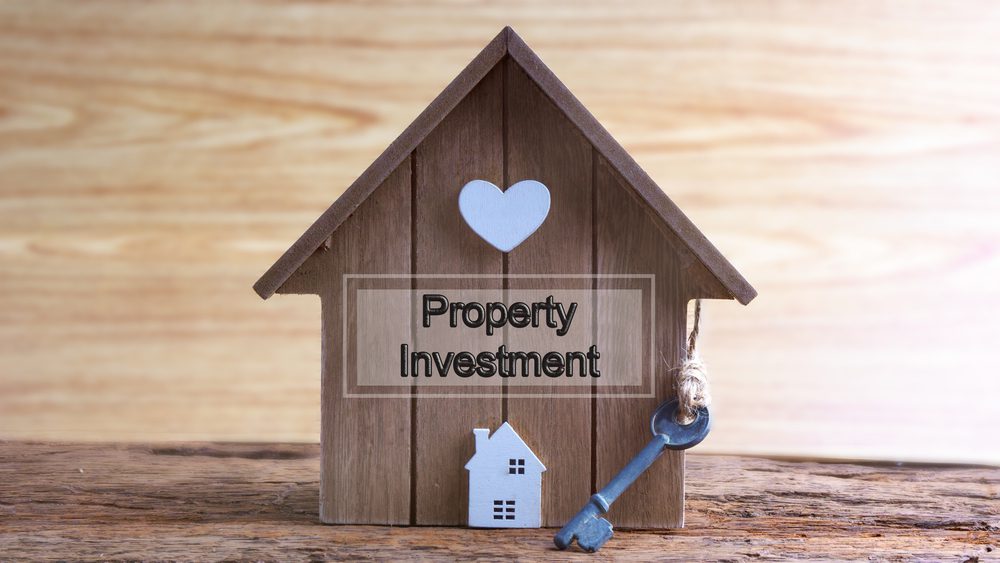 text 'property investment' on a house model
