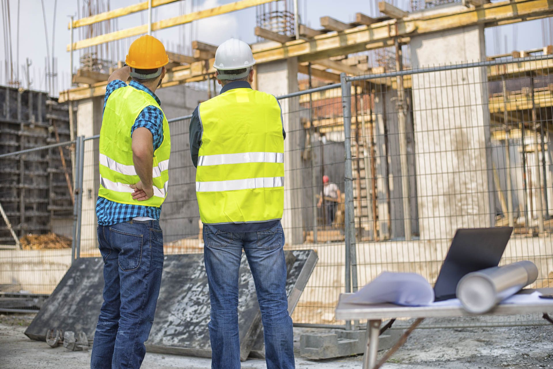 Two construction workers inspecting a development site