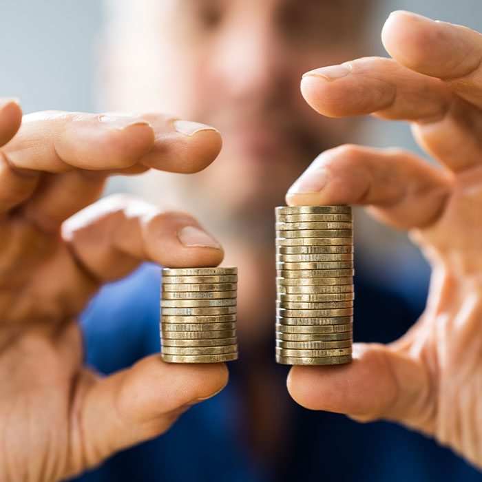 Person-holding-two-stacks-of-coin