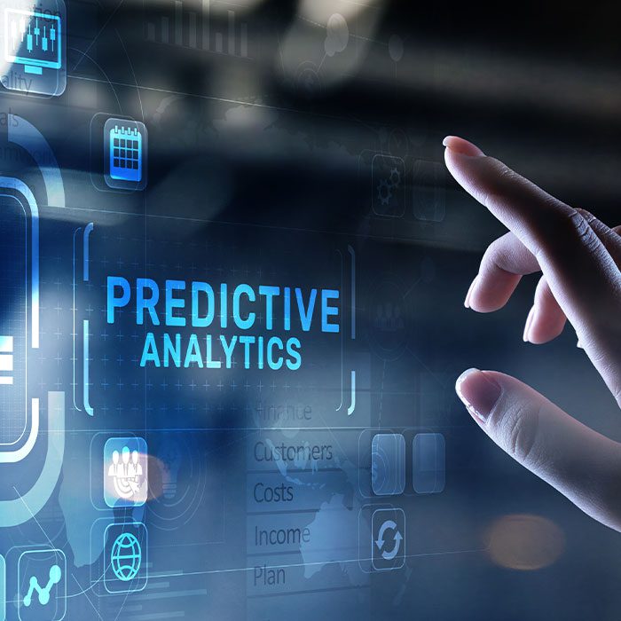 Hand pointing at hologram with 'predictive analytics'