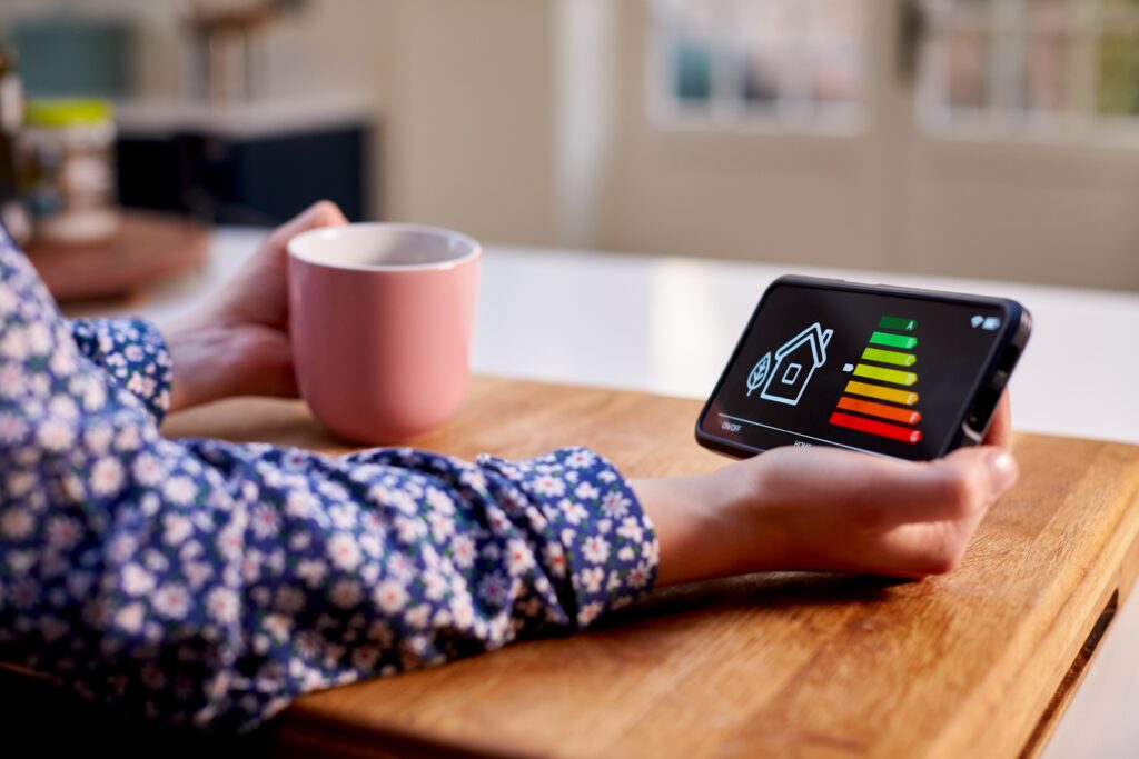 Woman sitting at a table checking the energy efficiency rating