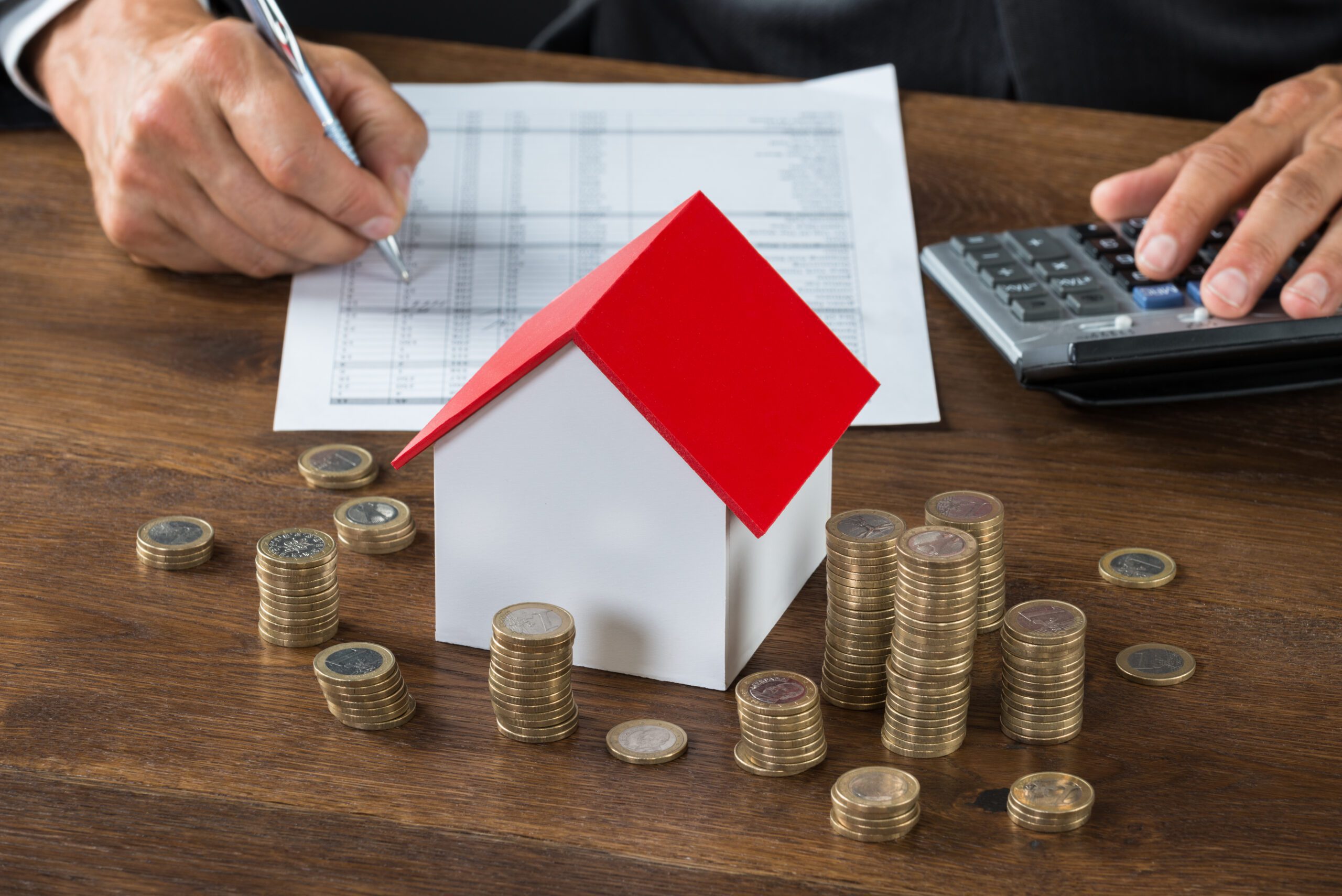 Return on Investment - Model House With Stacks of Coins