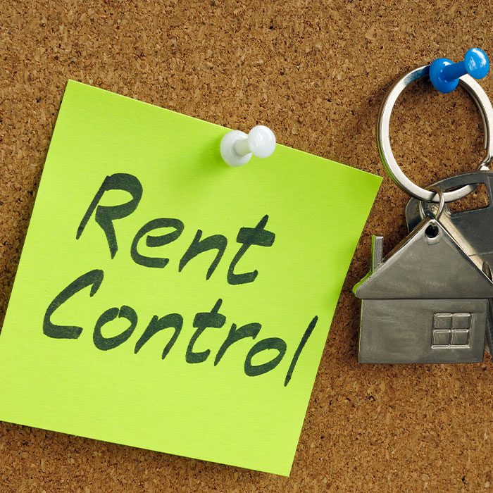 Rent control sticky note with house-shaped key ring