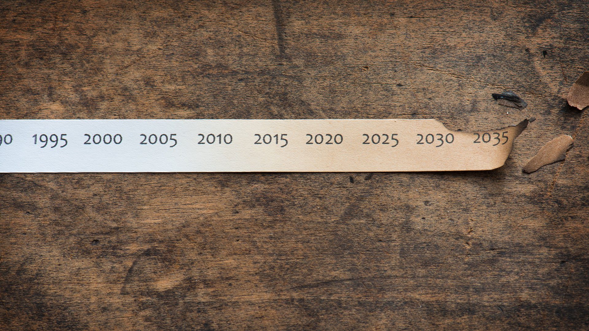 A paper strip with years from 1995 to 2035