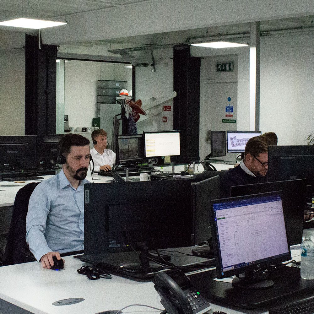 Employees at RWinvest, Liverpool, working on computers in the office