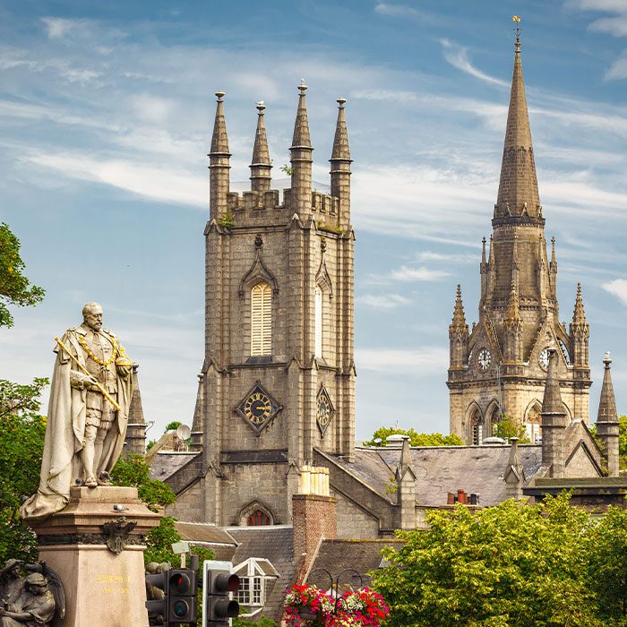 Statue of Edward VII with Former South Church with Kirk of St Nicholas (Triple Kirk) in the background, in Aberdeen, Scotland, UK