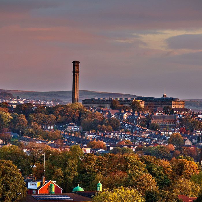 An aerial shot of an old mill in the city of Bradford under the gloomy clouds in Yorkshire, England