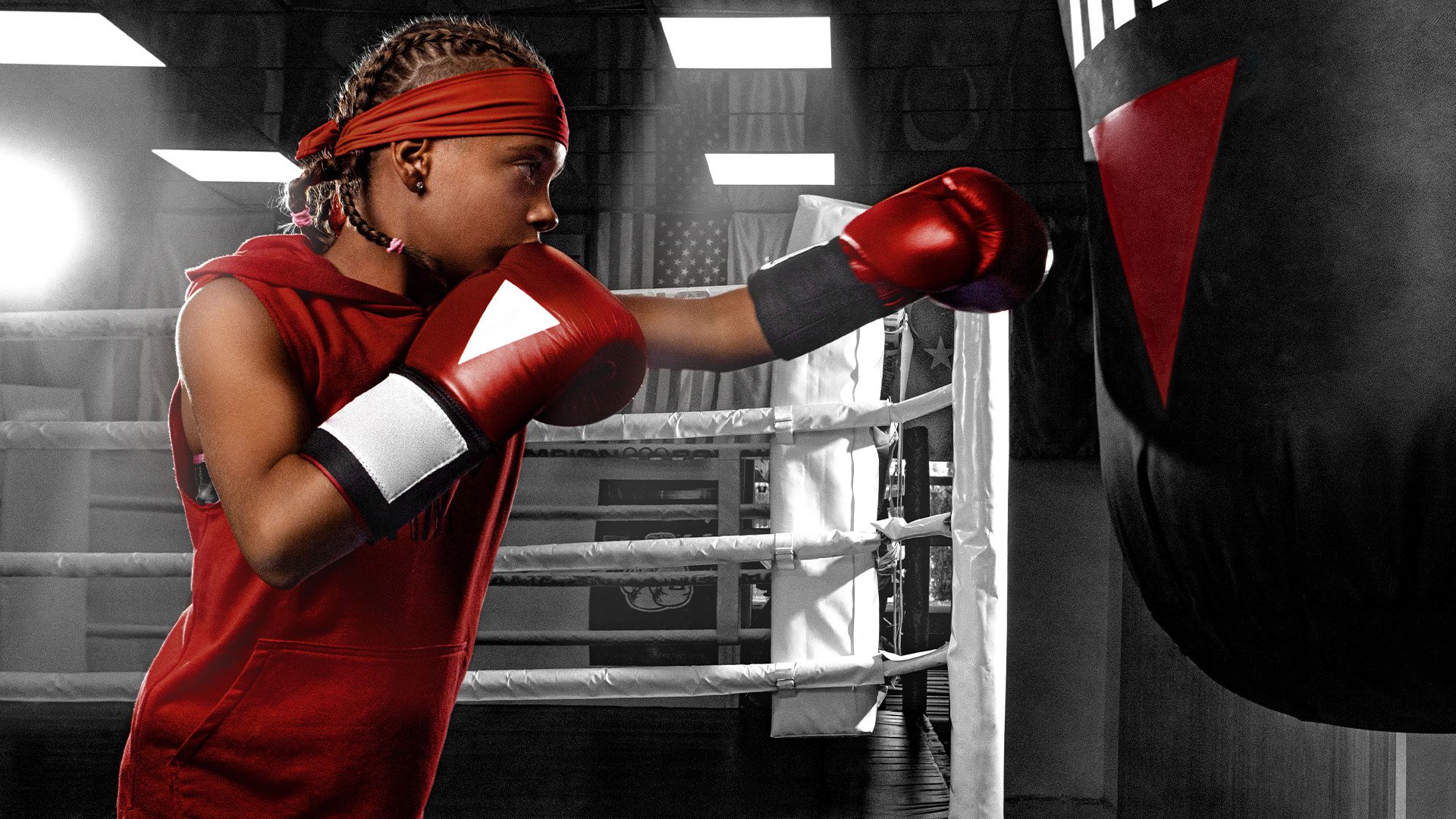A kid hitting a punching bag