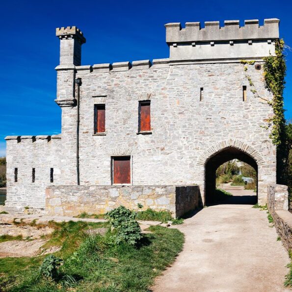 The 19th-century folly known as Radford Castle located on a dam separating the freshwater Radford Lake Plymstock Plymouth Devon England UK