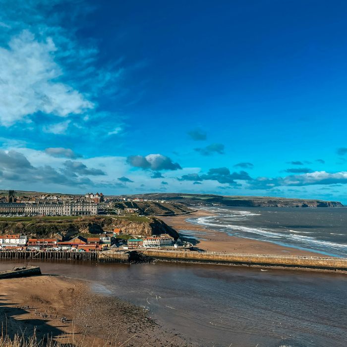 A view of a beach and a city from the top of a hill in Ellesmere Port