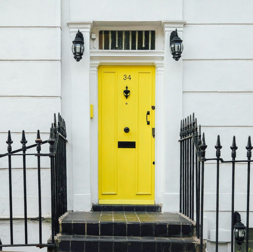 house with railings and a yellow door