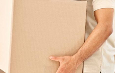 Man moving boxes into a property