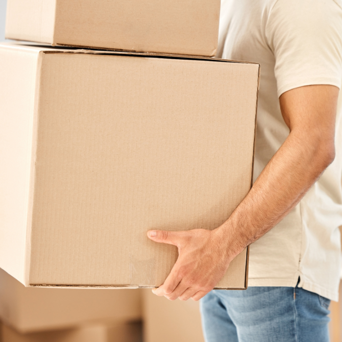 Man moving boxes into a property