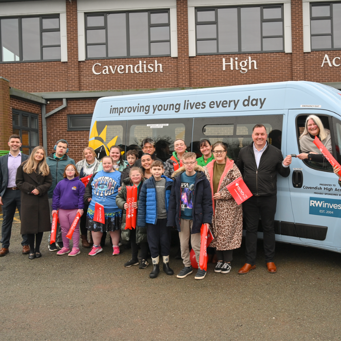 RWinvest and Cavendish High Academy pose next to new Sunshine Coach
