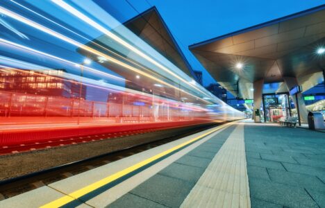 Image showing high-speed train moving quickly past platform