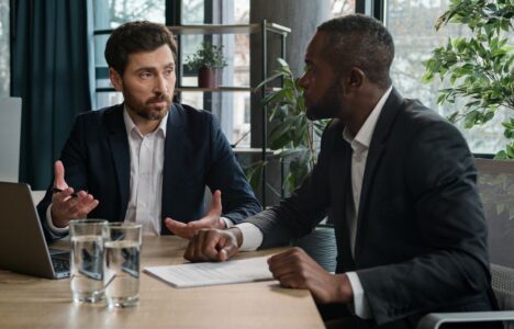 men in business attire speaking to each other