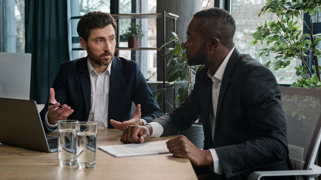 men in business attire speaking to each other