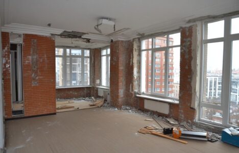 interior of a room with brick walls and windows being renovated