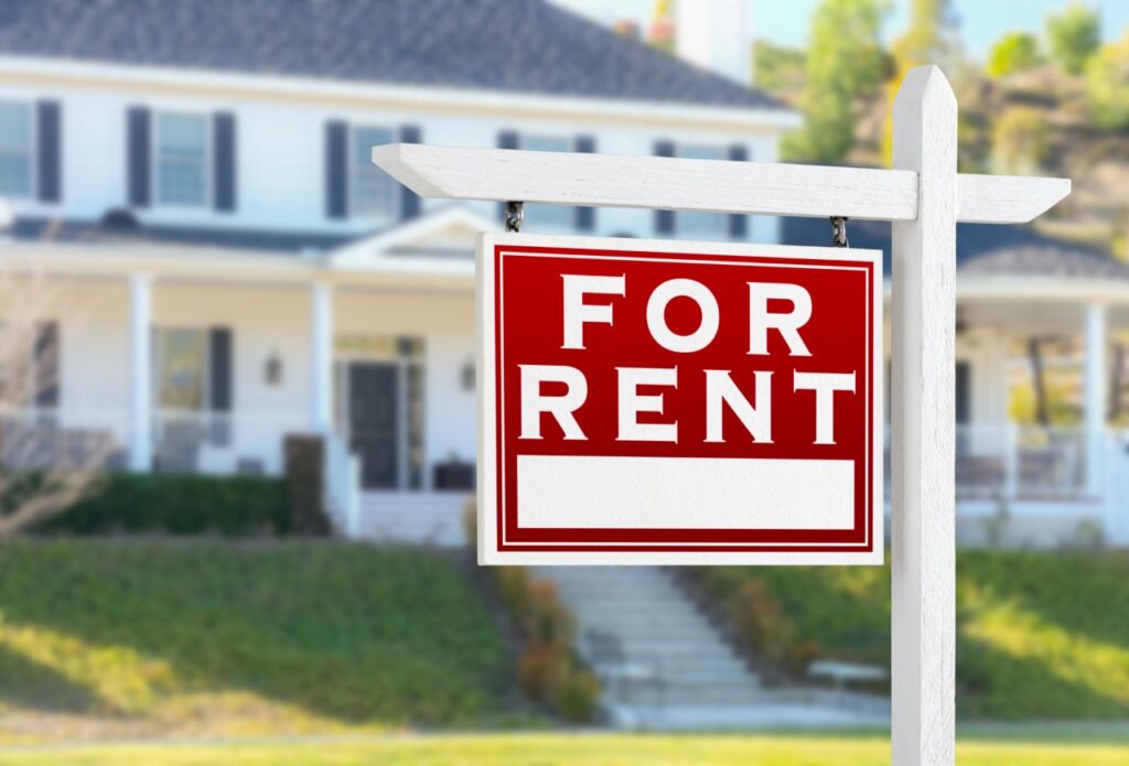 for rent sign hanging in front of a rental property