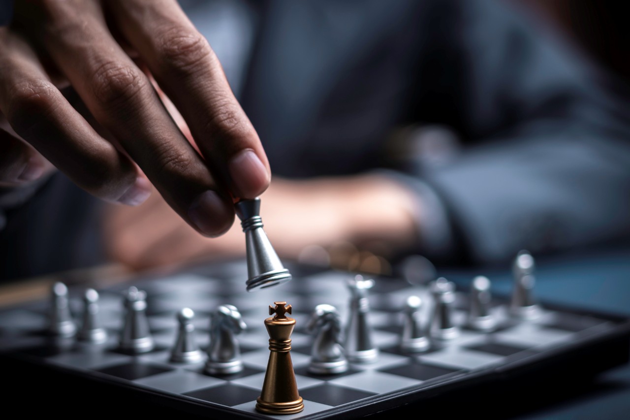 close up shot of a man's hand playing chess