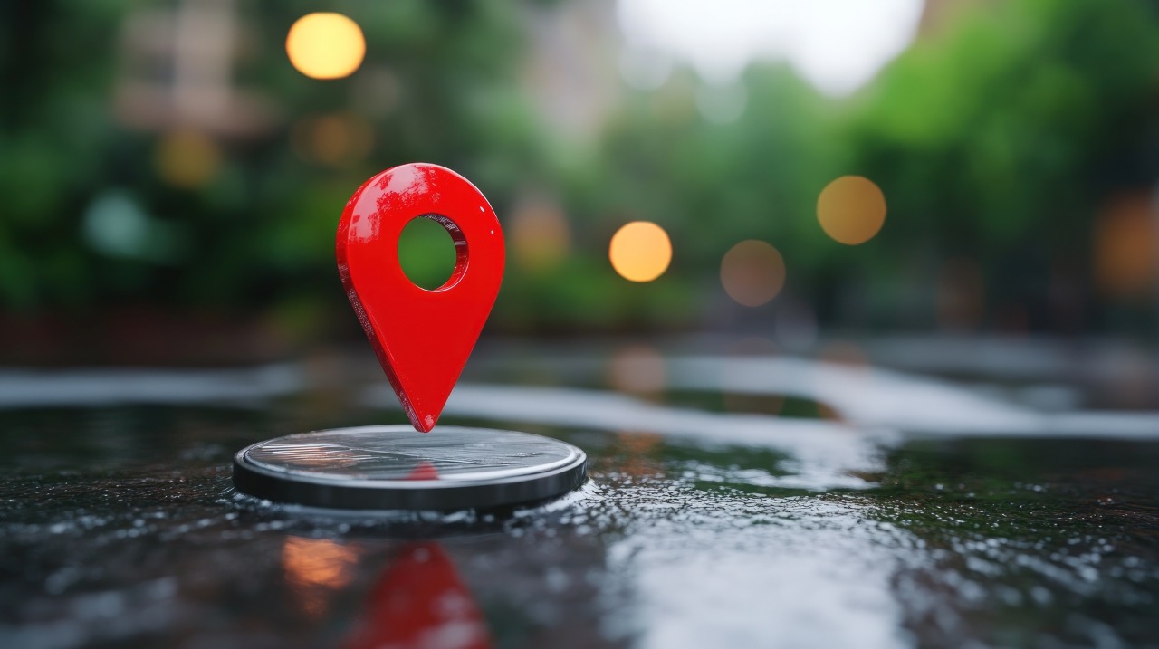 Red location pin on wet pavement