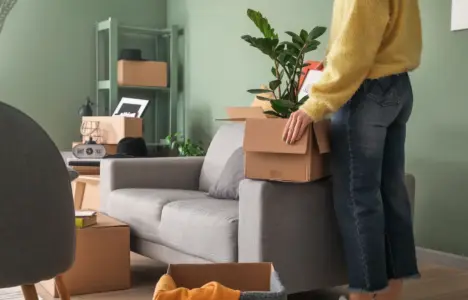Woman with boxes moving into new rental home