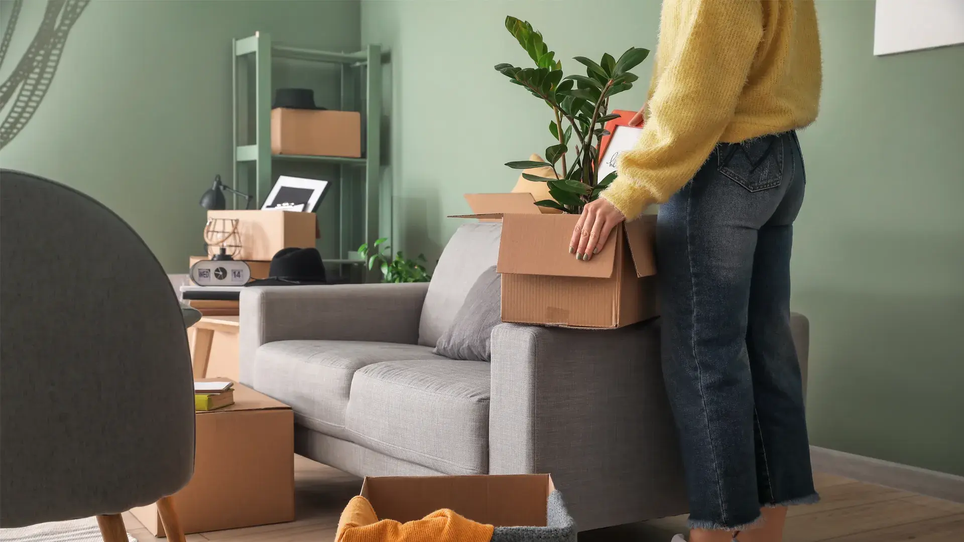 Woman with boxes moving into new rental home