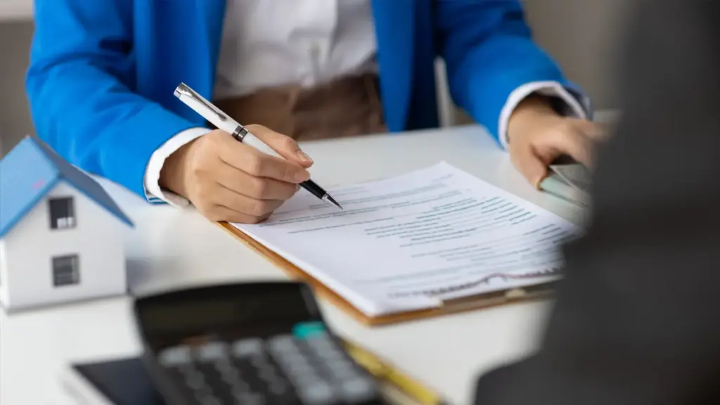 Person signing rental agreement documents