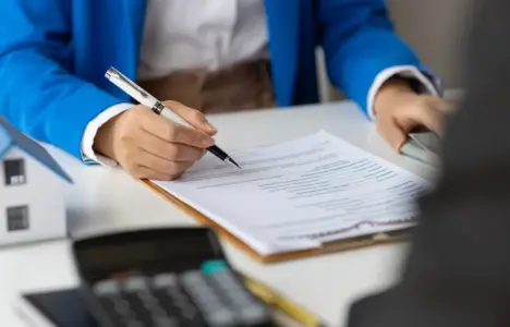 Person signing rental agreement documents