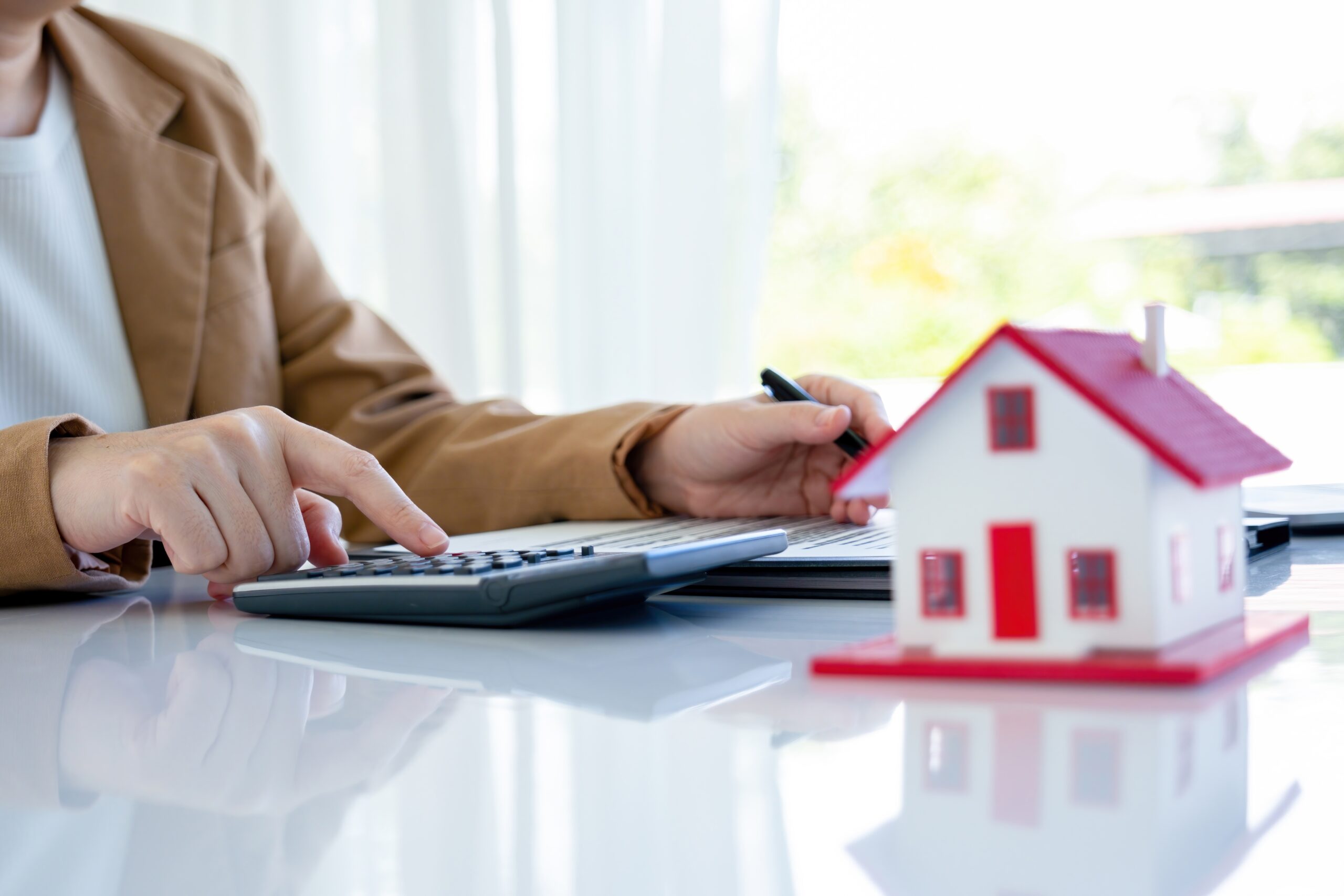 Business meeting for property investor, sitting at desk with calculator