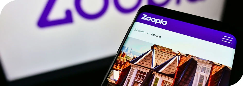 Person holding a phone with Zoopla opened